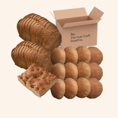 12 low carb rolls, 2 400g low carb loaves, a low carb focaccia bread and a cardboard box on a cream background