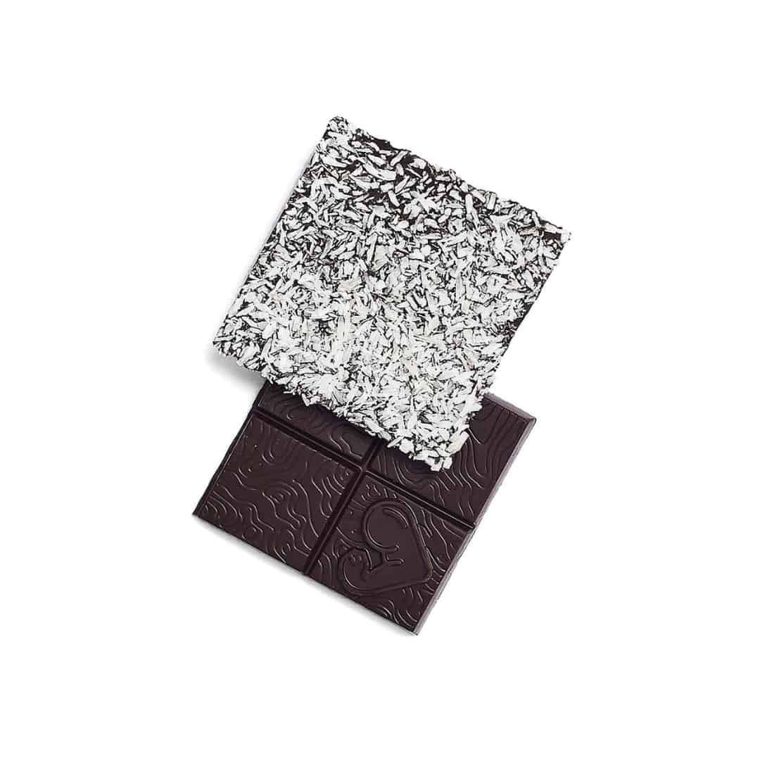 Funky Fat Choc Coconut 4 Funky Fat Choc Coconut showing two squares of the chocolate, one of the background with coconut