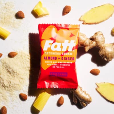 fatt almond ginger keto cookie in packaging with ginger, almonds and flour spread around
