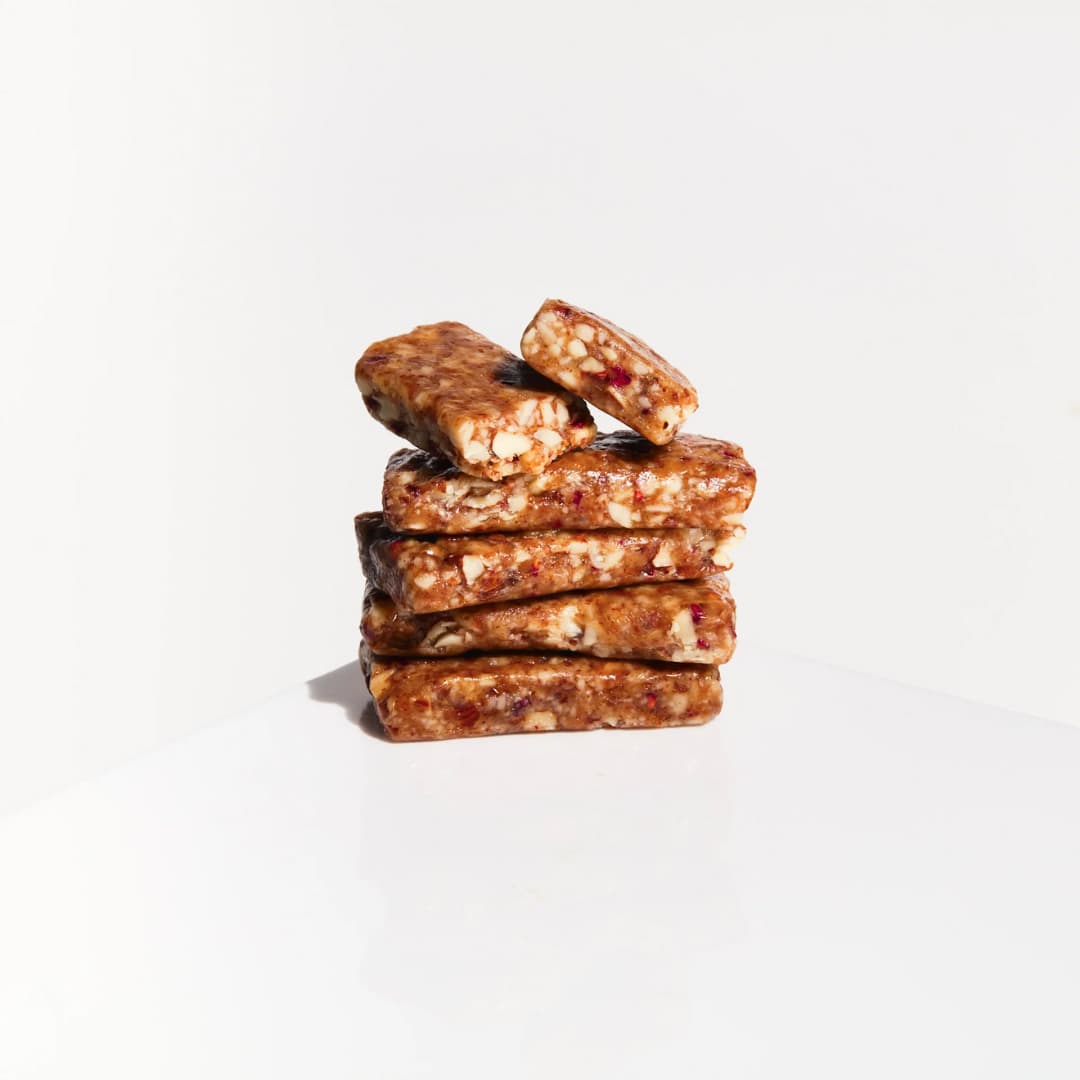 Fatt - Raspberry + Almond 3 Fatt - Raspberry + Almond bar, staked on top of each other on a grey background