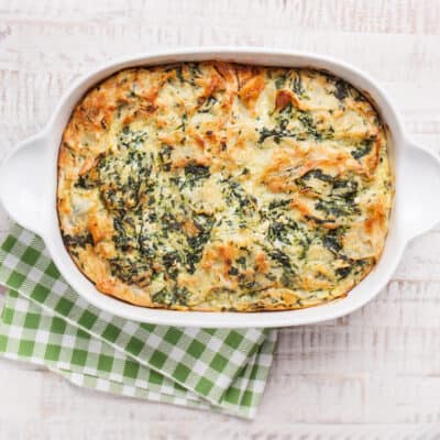 low carb chicken broccoli casserole seen from above, on a table with a green and white checkered tea towel