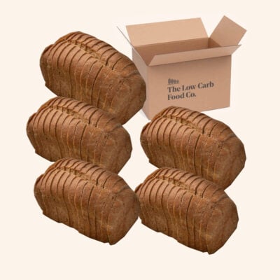 five low-carb sliced loaves on a cream background, with a cardboard box
